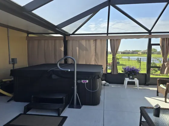 Tan Sunbrella outdoor privacy curtains installed in The Villages FL pool cage