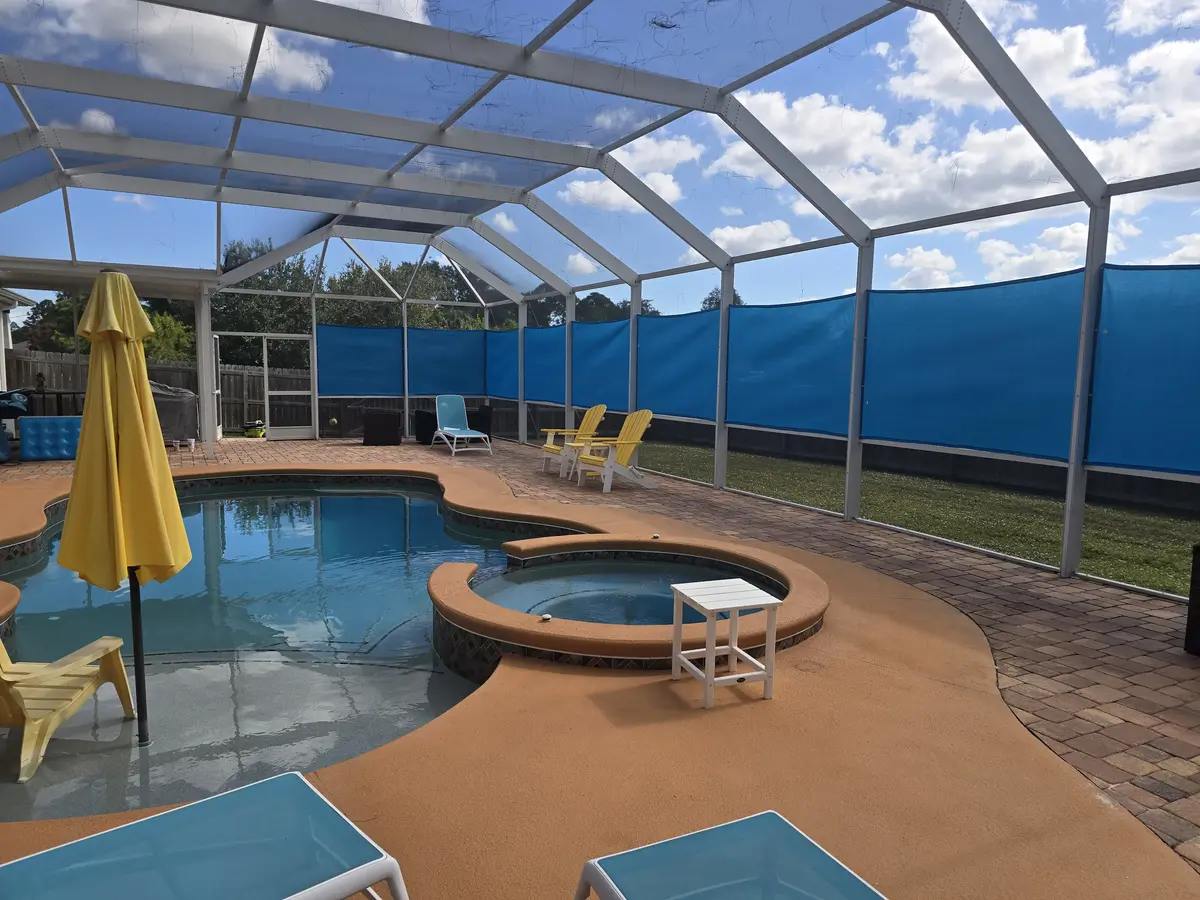 Blue UV-resistant mesh privacy panels permanently installed in Florida pool cage