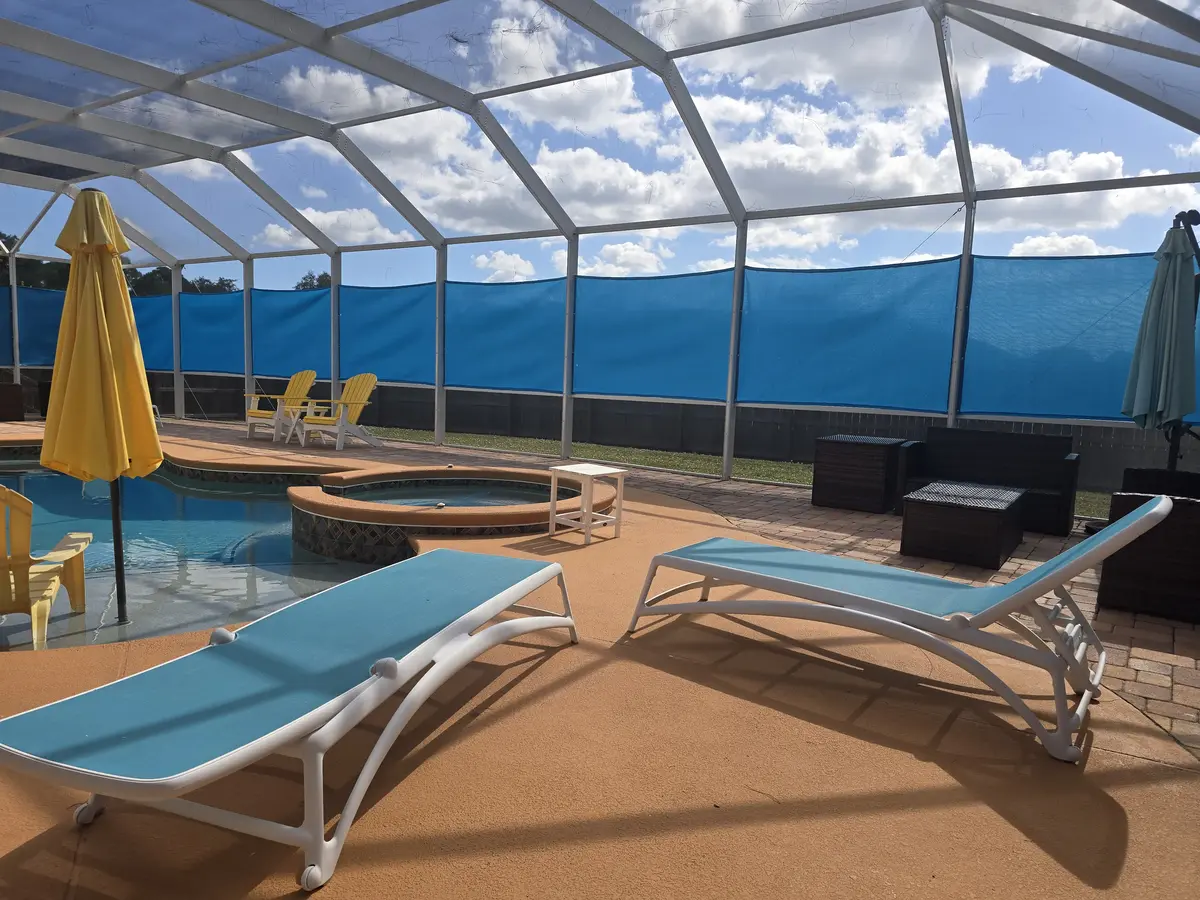 Breathable mesh privacy panels for wind reduction in Florida screen enclosure